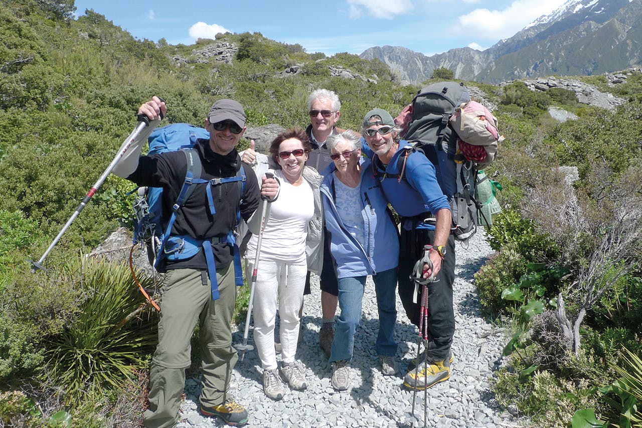 Relieved family members embrace Mike Fyfe (left) and his guide Marty Schmidt after the successful trip.