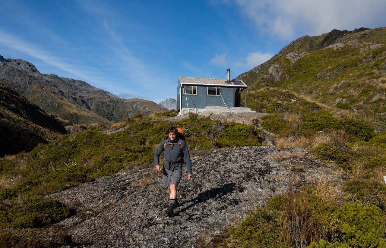 Leaving the comfort of bluff hut in rare sunshine.