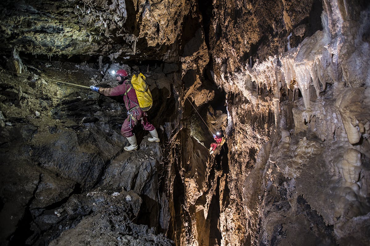 Cavers follow traverse lines across the intimidating 'Who Dares Wins' climb near the end of Bulmer. Photo: Neil Silverwood