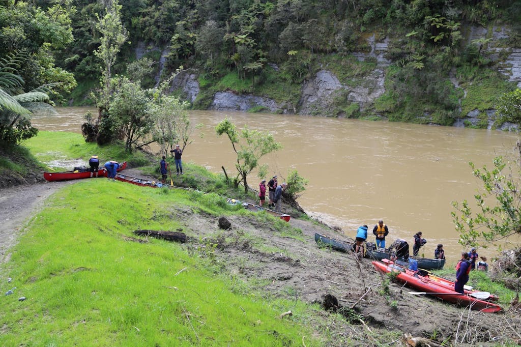 Kayakers prepare for take-off into a high river from John Coull Hut .Photo: Matthew Pike 