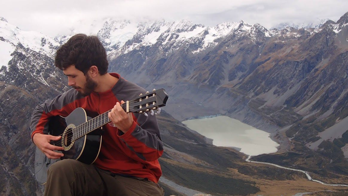 Lindsay Maggard plays the Mueller Hut Guitar. Photo: Tararua Tramping Club