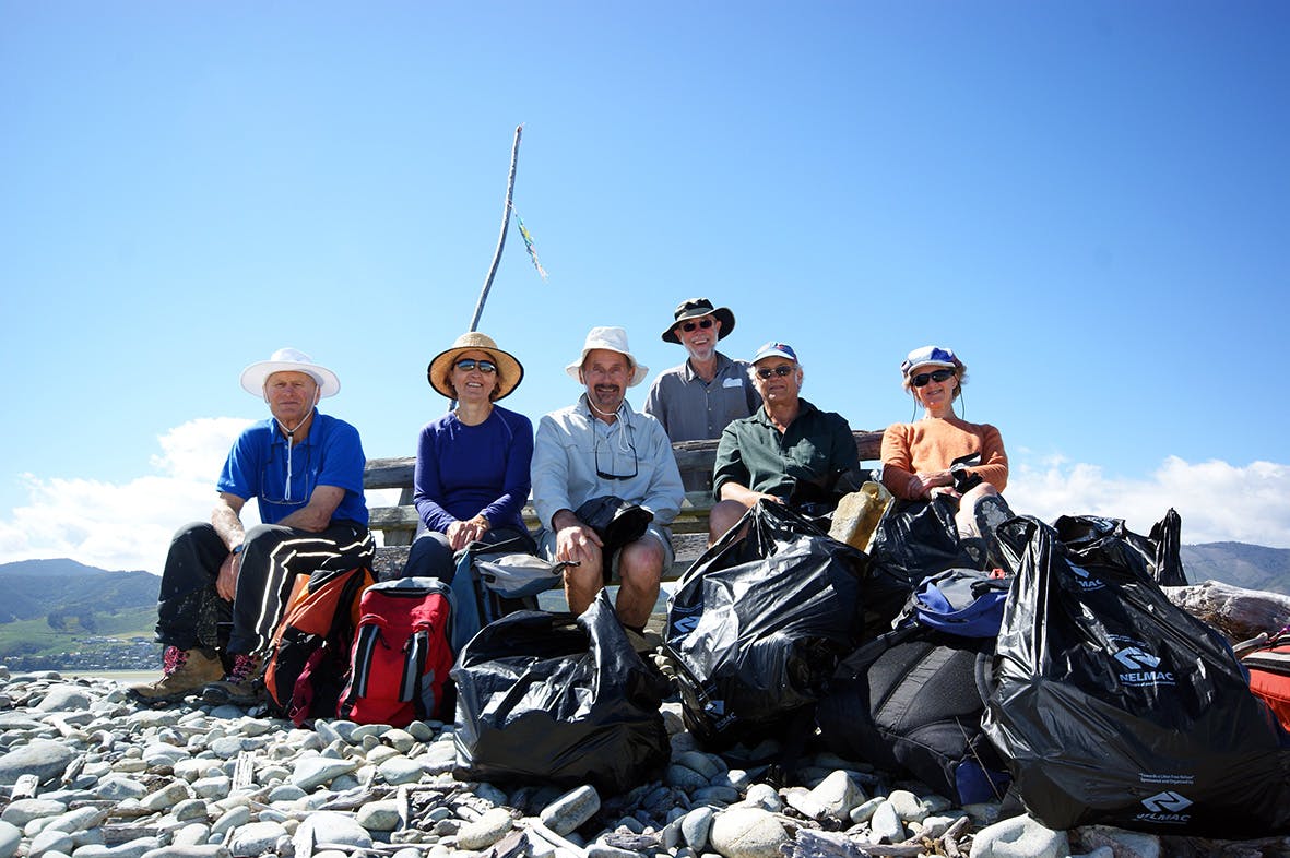 Volunteers from a tramping club fill bags of debri on Nelson's Boulder Bank. Photo: Ray Salisbury
