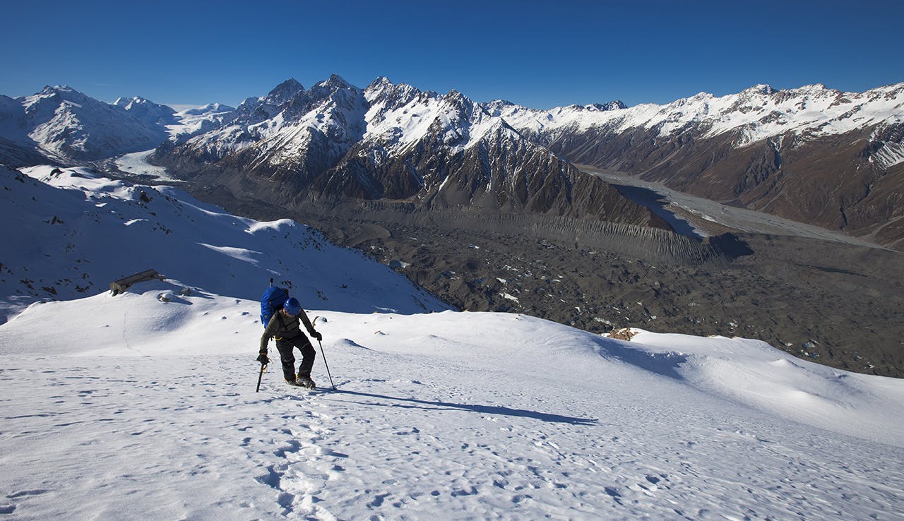 Climbing to Ball Pass, just above Caroline Hut, Tasman Glacier and Malte Brun Range in background. Photo: Mark Watson