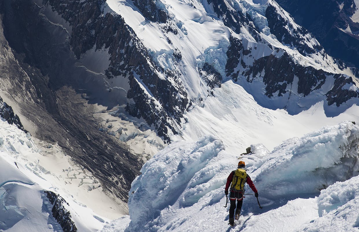 Descending the summit icecap of Aoraki/Mt Cook with the Haast avalanche scar far below. Photo: Mark Watson