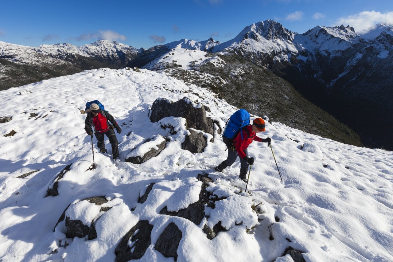 Traversing the Lockett Range after an unexpected snowfall. Waingaro Peak in background