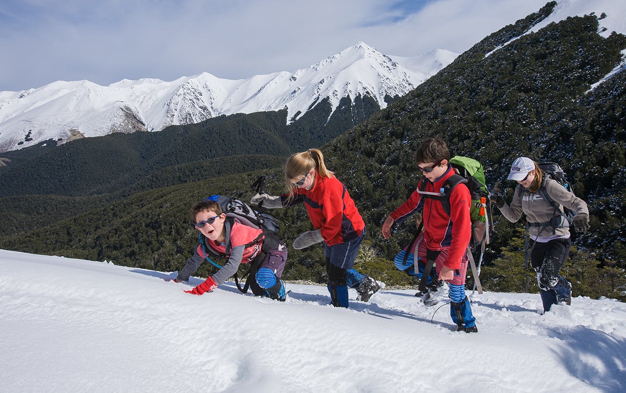 Enjoying the snow on the way up Helicopter Hill. Photo: Angus McIntosh