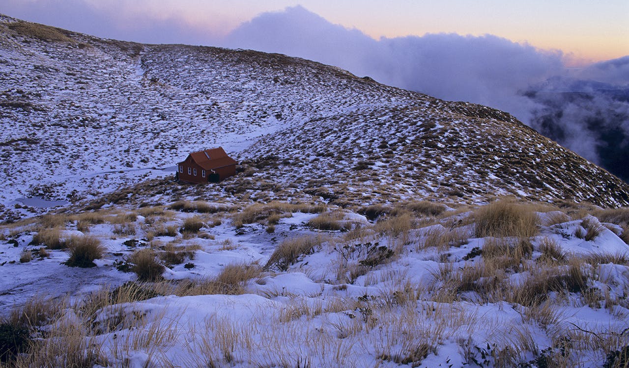 Dusk approaches at Kime Hut (Note, this hut is not eh current version of Kime Hut). Photo: Shaun Barnett/Black Robin Photography