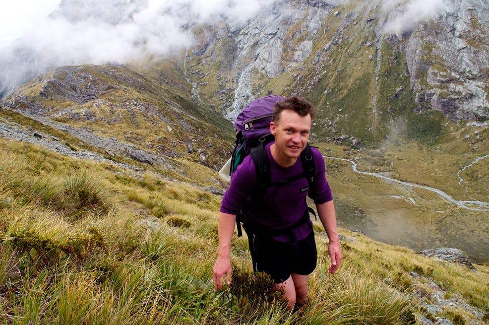 Traversing the steep snowgrass slopes on the ridge leading from Park Pass to Lake Nerine. Photo: Carl Walrond