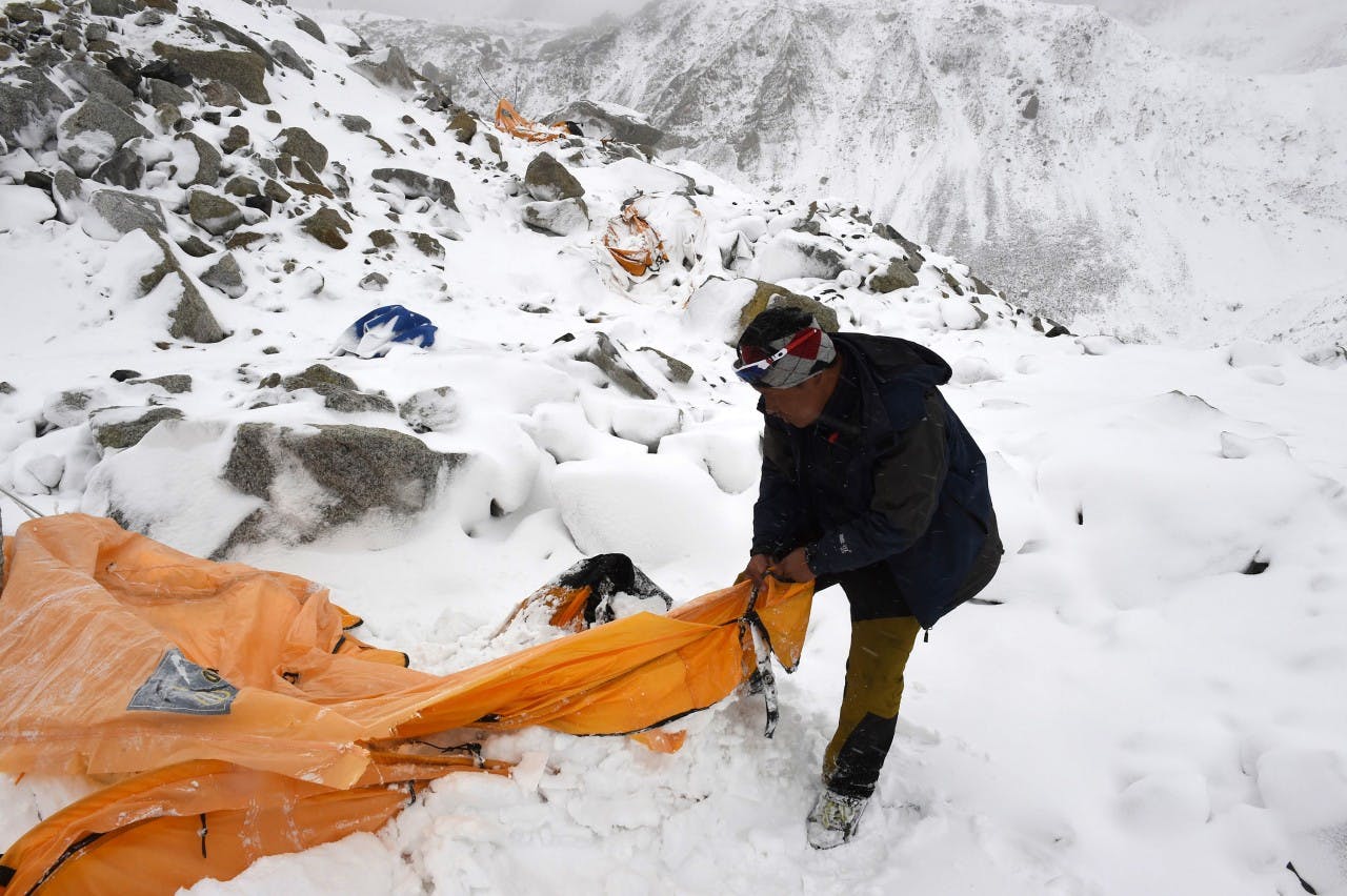Trekking guide Pasang Sherpa searches for survivors among flattened tents moments after the avalanche at Everest Base Camp. PHOTO: Roberto Schmidt