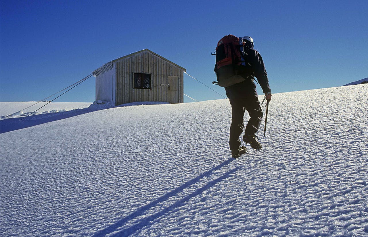 A climber approaches Syme Hut, Fantoms Peak. Photo: Shaun Barnett/Black Robin Photography