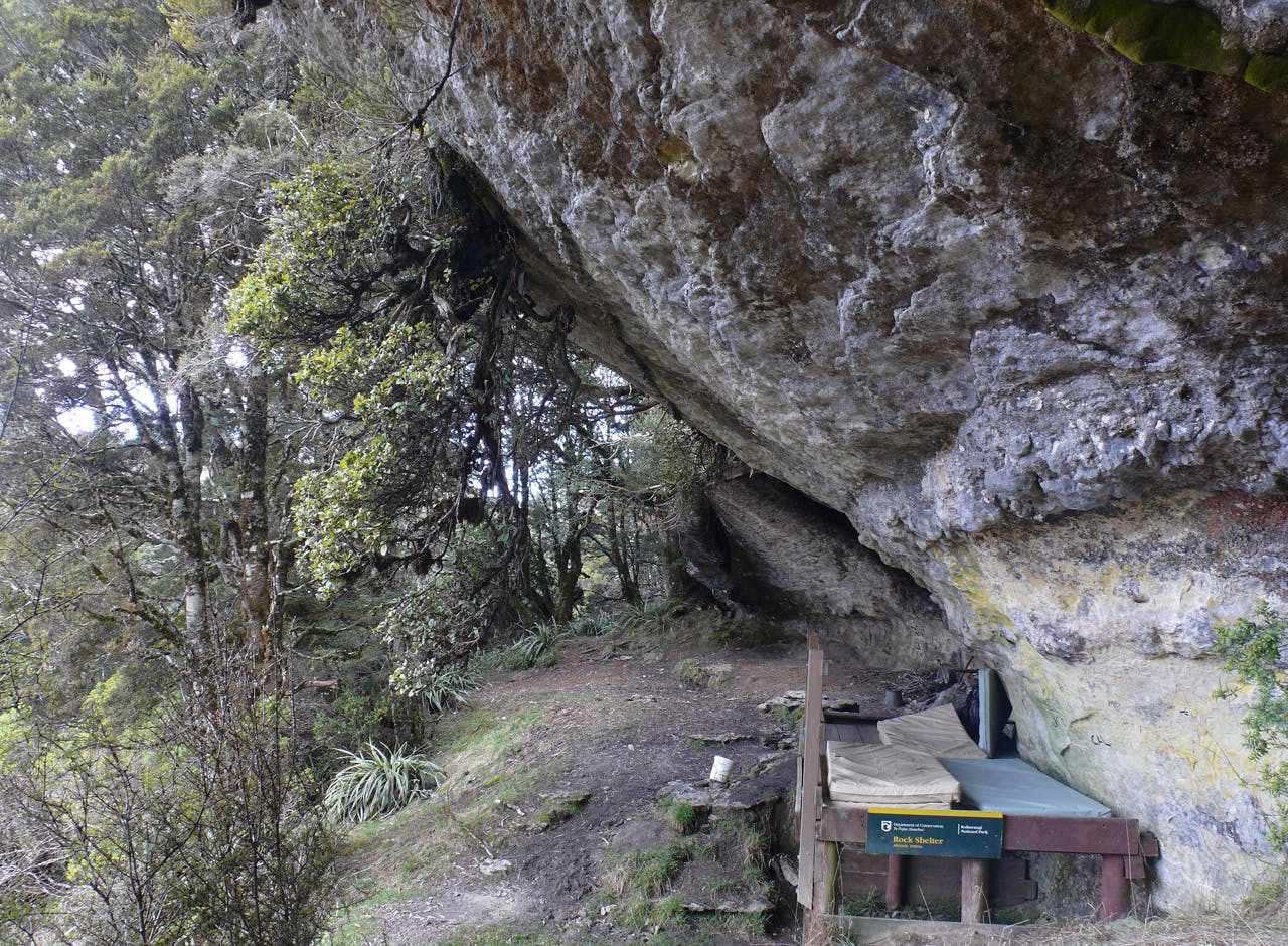 Dry Rock Shelter in Kahurangi National Park has sleeping platforms and room for a fire. Photo: Geoff Spearpoint