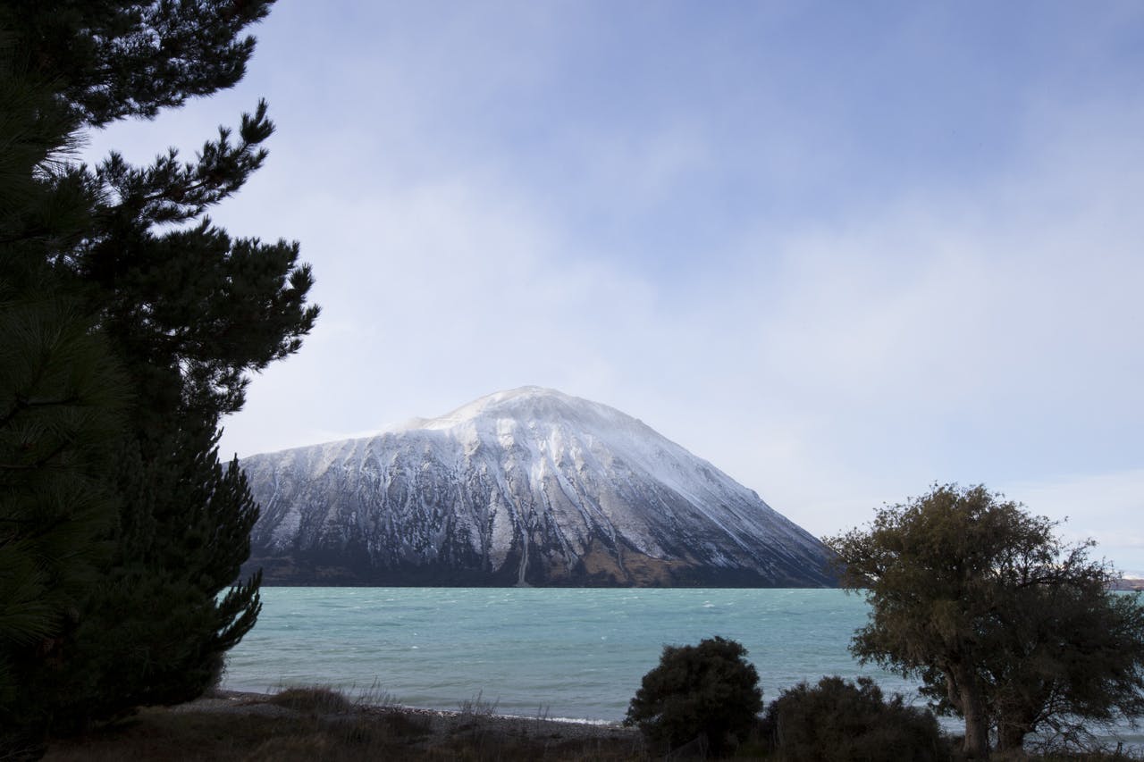 Snow storm rolls in over mountains above Lake Ohau, South Canterbury, New Zealand. Photo: www.derekmorrison.co.nz