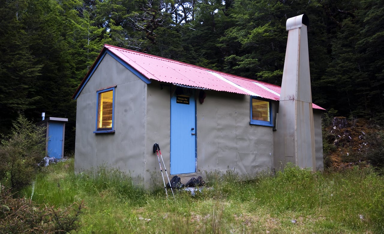Otahake Hut squats in a clearing above the river. Photo: Raymond Salisbury