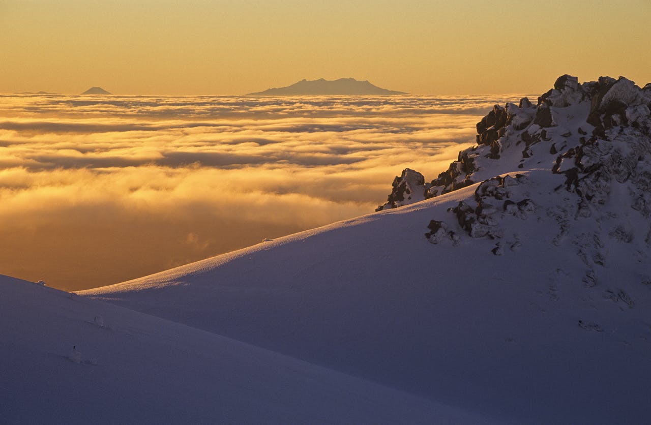 Sunrise over Mt Ngauruhoe and Mt Ruapehu from Taranaki’s Fantham's Peak. Photo: Shaun Barnett