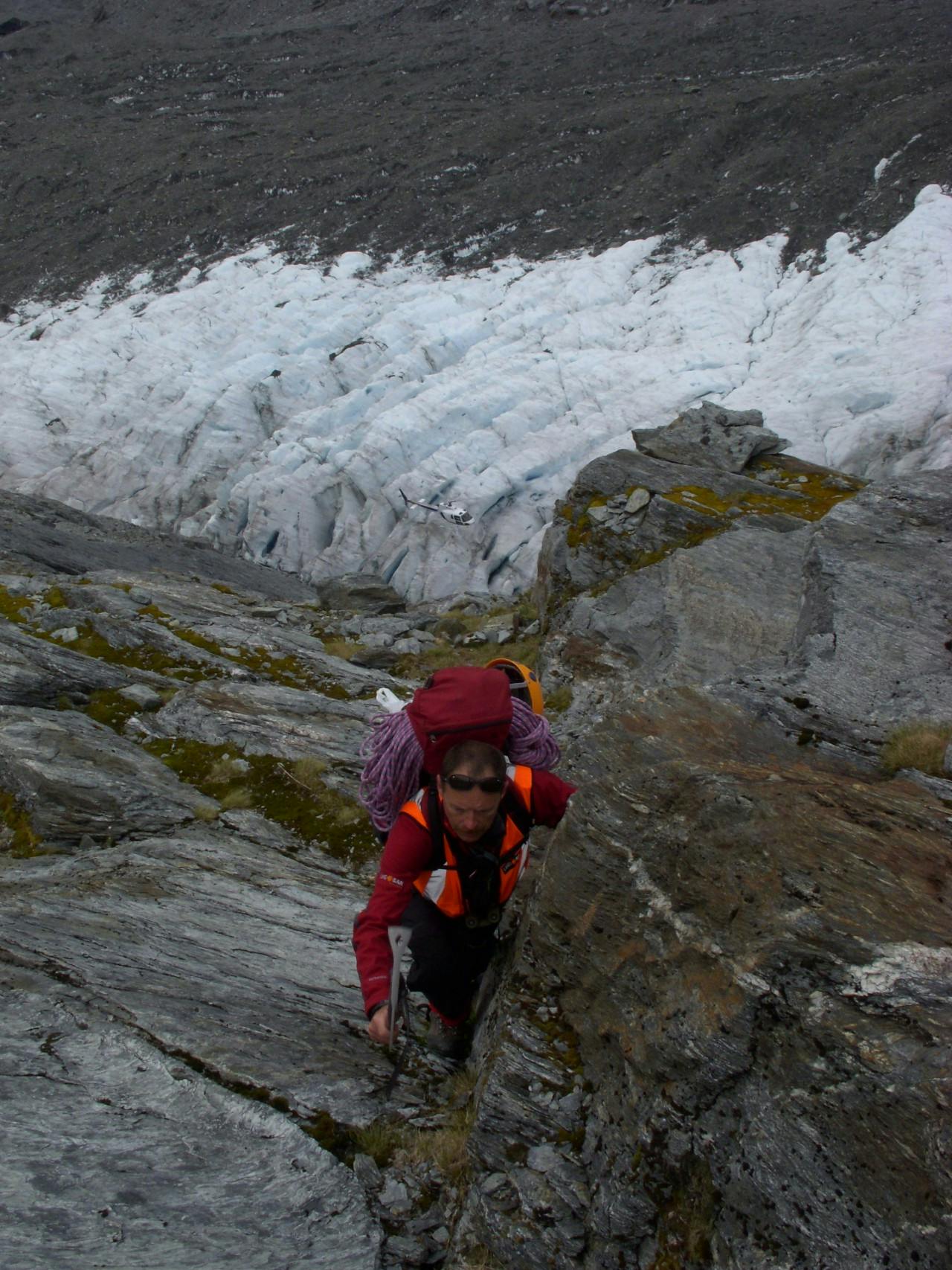 A SAR volunteer climbs above the Dart Glacier on a training exercise