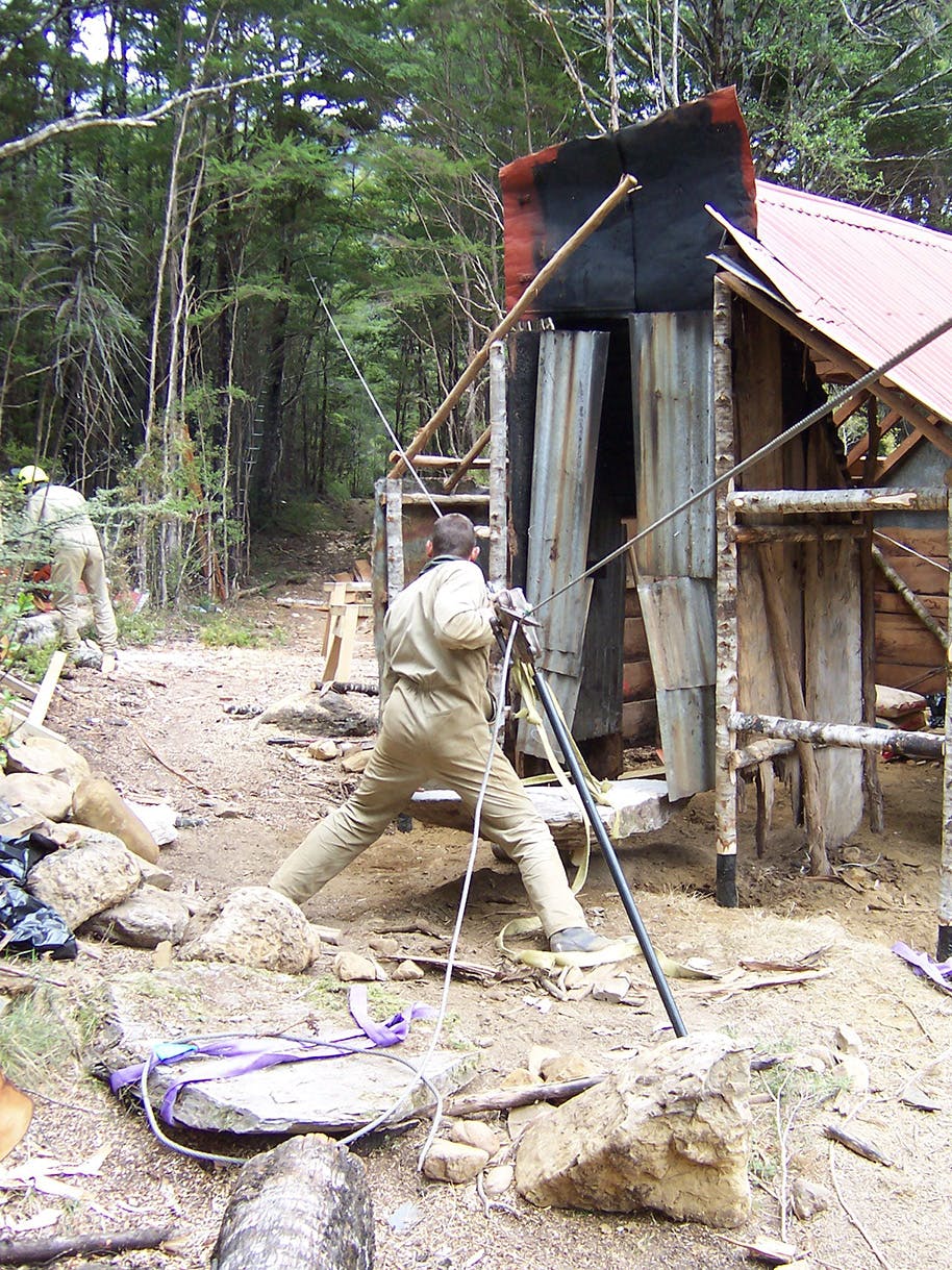 Rebuilding the hearth at Waingaro Forks hut required some heavy lifting. Photo: John Taylor