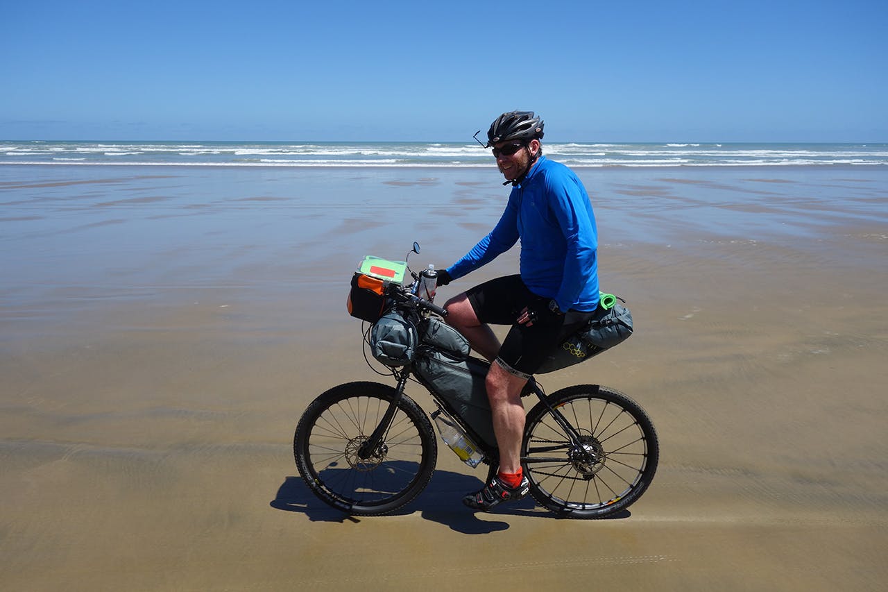 Lightweight bikepacking bags are gaining popularity but don’t hold as much gear as traditional panniers. Photo: Jonathan Kennett