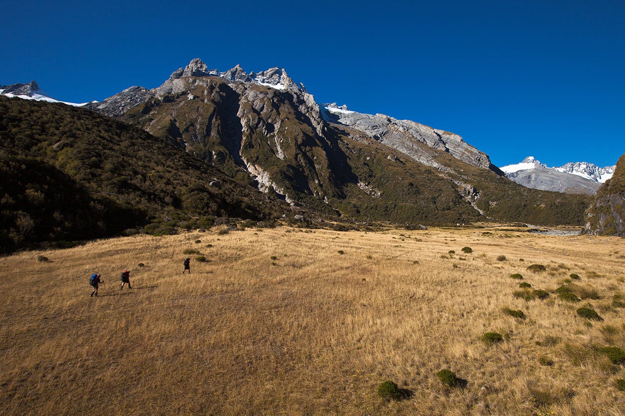 Crossing the river flats towards Horace Walker Hut - a mere spec beneath the bulk of Pioneer Peak. Photo: Mark Watson