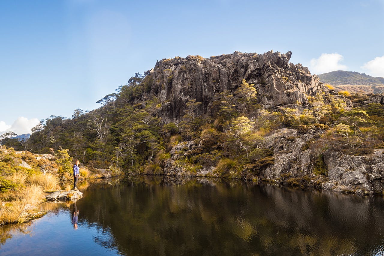 Fenella Hut's charms include this gorgeous tarn. Photo: Jack Houghton