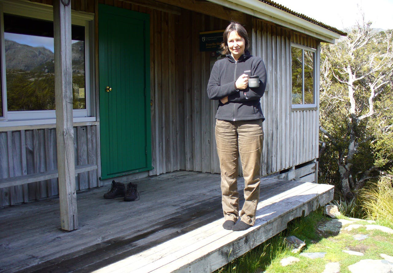 The author sips tea at Fenella Hut – her first tramp in 35 years. Photo: David Dewes.